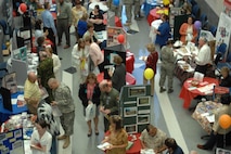 Personnel from NORAD and USNORTHCOM visit the first ever Combined Federal Campaign Rally and Charity Agency Fair Oct. 7 at the commands' headquarters. The 2008 CFC campaign "is not about money, not about goals," said NORAD and USNORTHCOM Chief of Staff, Maj. Gen. John H. Bordelon. "It's about helping people in need." Representatives from more than 20 CFC charities were present, sharing their charities with the men and women of the commands. Photo by Petty Officer 1st Class Joaquin Juatai 