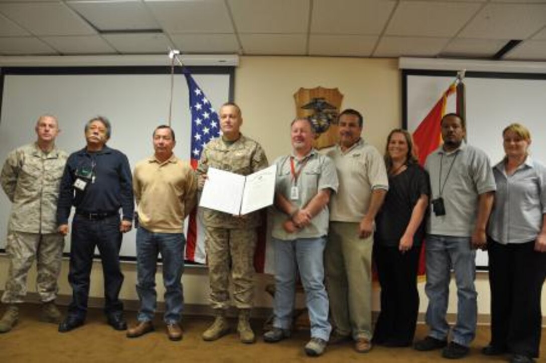 The safety office on Marine Corps Logistics Base Barstow and Col. Michael L. Scalise, base commanding officer, pose for a photo after their office was recognized for their achievements in the past year during MCLB Barstow's Quarterly Awards Breakfast, April 23 at the Maj. Gen. James L. Day Conference Center. The safety office was presented the Gen. James L. Jones Unit Safety Award by Secretary of the Navy Ray Mabus and Phillip L. Dunmire, the National President of the Navy League, during the Navy League Luncheon, April 10, in National Harbor, Md