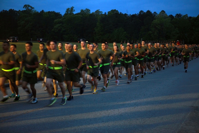 Marines and sailors with 2nd Marine Logistics Group run in formation approximately three miles during a unit run at Soifert field aboard Camp Lejeune, N.C., April 25, 2013. Noncommissioned officers with the unit led their companies in the run by yelling cadences to motivate each other. 