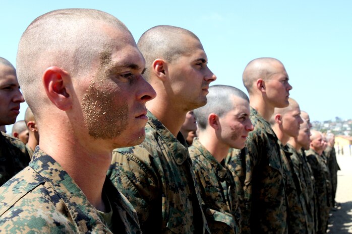 Recruits of Company A, 1st Recruit Training Battalion, listen to an award citation prior to a pugil sticks event aboard Marine Corps Recruit Depot San Diego April 11. Award citations are often read to recruits, throughout training, to teach and illustrate past Marine's hardships and achievements.