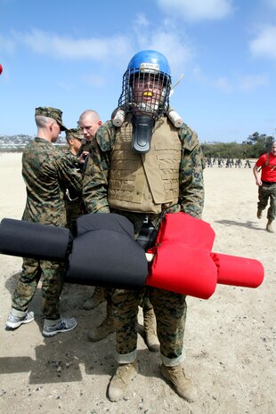 A recruit of Company A, 1st Recruit Training Battalion, wait for his turn to duel with a fellow recruit depot a pugil sticks match aboard Marine Corps Recruit Depot San Diego April 11. Recruits wear proper protective gear such as a mouth piece, helmet and groin protection to prevent injury.