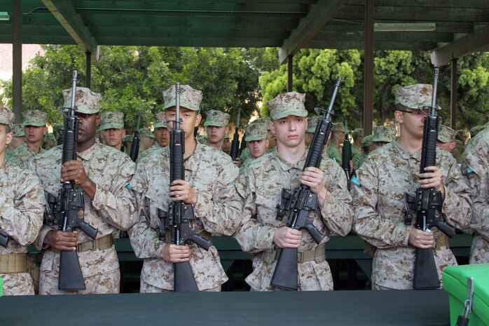 Recruits of K, 3rd Recruit Training Battalion, await further orders from their drill instructors after receiving their M-16 A4 service rifle aboard Marine Corps Recruit Depot San Diego April 8. Recruits will be required to learn how to disassemble and reconfigure their rifle. 