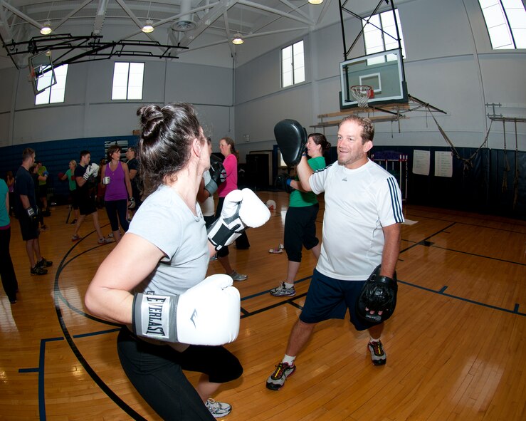 Members of the Niagara Falls Air Reserve Station engage in a fitness class offered at the Fitness Center, April 11, 2013, Niagara Falls, N.Y. The class utilizes free weights, spinning bikes, aerobic steps, kettlebells, medicine balls, suspension straps, stability balls, BOSU trainers, yoga and martial arts techniques; No two workout sessions are the same. (U.S. Air Force photo by Tech. Sgt. Joseph McKee)