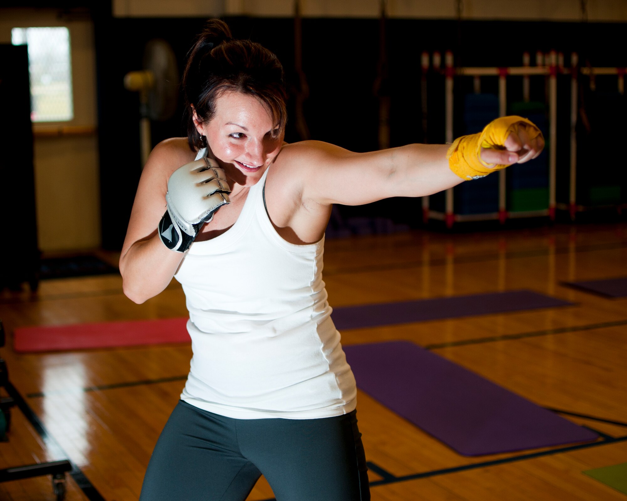 Master Sgt. Charity Edwards, 914th Force Support Squadron First Sergeant uses her skills as a certified physical trainer during a fitness class offered at the Niagara Falls Air Reserve Station Fitness Center, April 11, 2013, Niagara Falls, N.Y. The class utilizes free weights, spinning bikes, aerobic steps, kettlebells, medicine balls, suspension straps, stability balls, BOSU trainers, yoga and martial arts techniques; No two workout sessions are the same. (U.S. Air Force photo by Tech. Sgt. Joseph McKee)