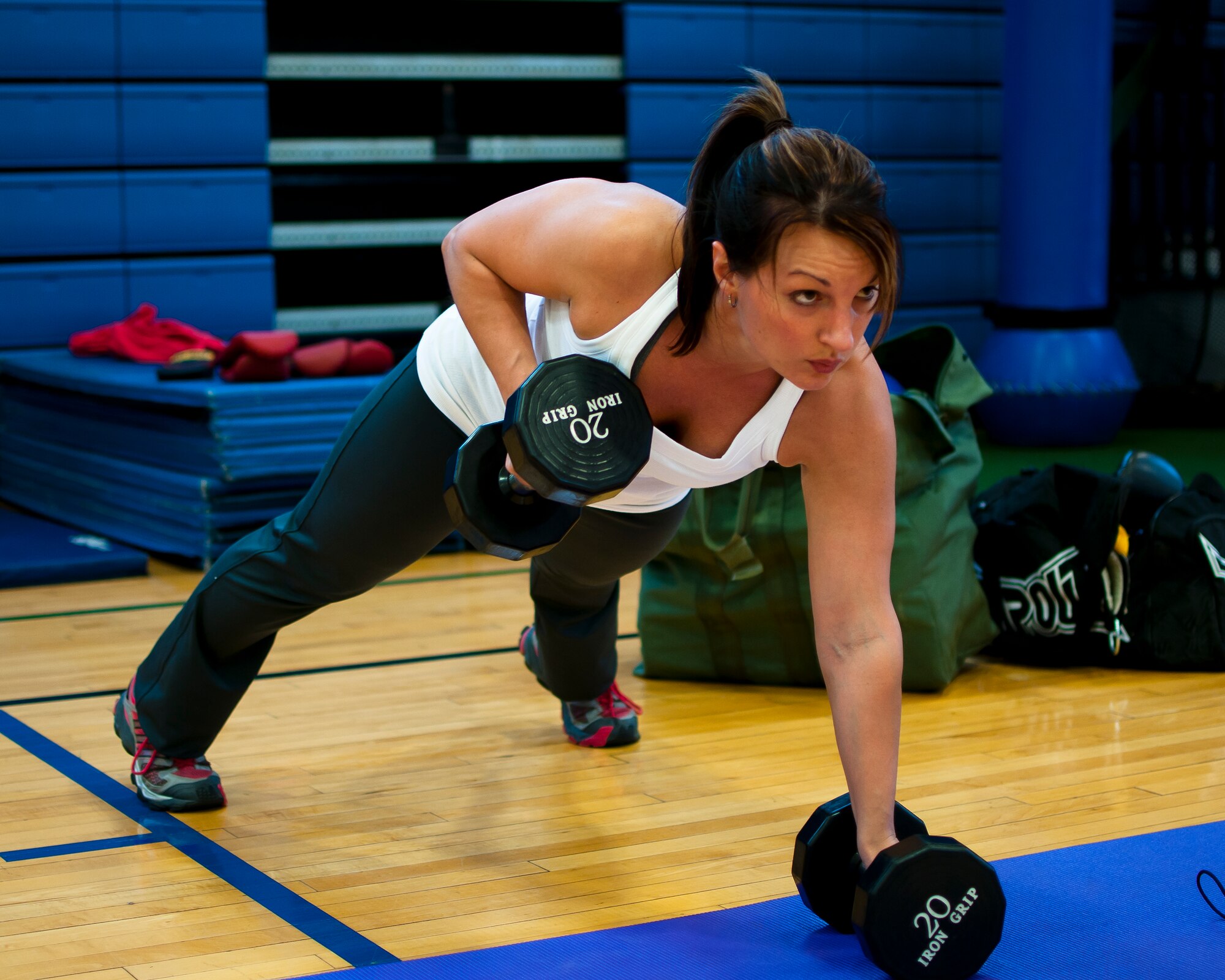Master Sgt. Charity Edwards, 914th Force Support Squadron First Sergeant uses her skills as a certified physical trainer during a fitness class offered at the Niagara Falls Air Reserve Station Fitness Center, April 11, 2013, Niagara Falls, N.Y. The class utilizes free weights, spinning bikes, aerobic steps, kettlebells, medicine balls, suspension straps, stability balls, BOSU trainers, yoga and martial arts techniques; No two workout sessions are the same. (U.S. Air Force photo by Tech. Sgt. Joseph McKee)