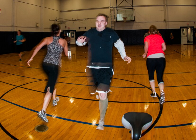 Members of the Niagara Falls Air Reserve Station engage in a fitness class offered at the Fitness Center, April 11, 2013, Niagara Falls, N.Y. The class utilizes free weights, spinning bikes, aerobic steps, kettlebells, medicine balls, suspension straps, stability balls, BOSU trainers, yoga and martial arts techniques; No two workout sessions are the same. (U.S. Air Force photo by Tech. Sgt. Joseph McKee)