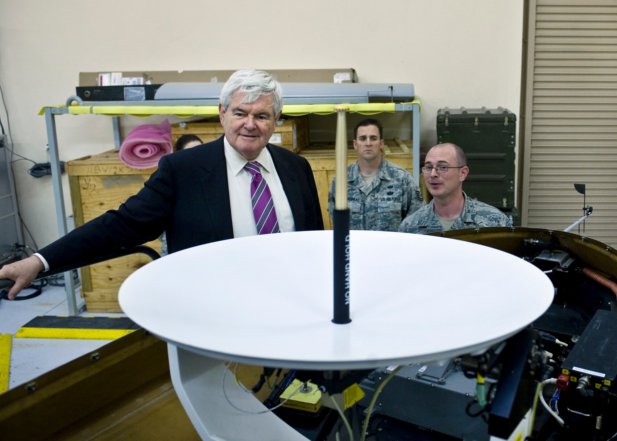 Newt Gingrich, former speaker of the U.S. House of Representatives, is briefed by Tech. Sgt. Christopher Delucia, Detachment 13 MQ-1 Predator maintenance instructor, April 24, 2013, at Nellis Air Force Base, Nev.  Delucia answered questions regarding the MQ-1 Predator and its role of being part of the Air Force inventory. Gingrich was in Las Vegas to be a keynote speaker at an event and toured Nellis AFB.  (U.S. Air Force Photo by Airman 1st Class Jason Couillard)