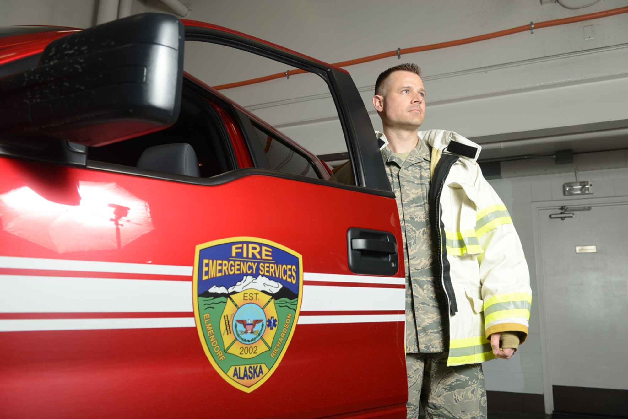 JOINT BASE ELMENDORF-RICHARDSON, Alaska -- Senior Master Sgt. Tobias Adam, 673d civil engineer squadron deputy fire officer poses for portrait photo by his emergency services response vehicle April 23. Adam was awarded the Pacific Air Force fire officer of the year award. (U.S. Air Force photo/Airman Ty-Rico Lea)