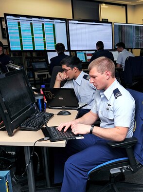 Cadet 3rd Class Zachary Madison (right) and Cadet 1st Class Ramon Villanueva take part in the National Security Agency’s Cyber Defense Exercise April 16. The exercise, which took place April 16-18, tested competitors' ability to defend a fully functioning computer network from attack. (U.S. Air Force photo/Sarah Chambers)