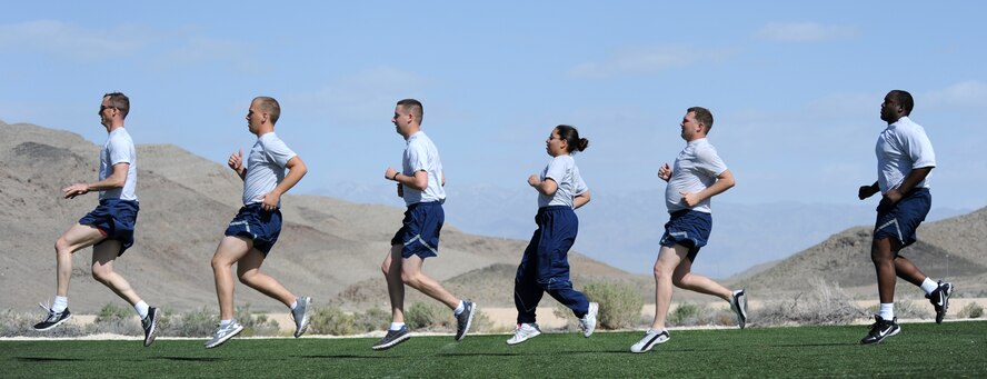 LAS VEGAS, Nev. -- Tech. Sgt. Scott leads a group in a high knee exercise during a unit workout session April 9, 2013. The section shift supervisor frequently attends 432nd Aircraft Maintenance Squadron unit fitness sessions and assists members to reach their personal fitness goals. (U.S. Air Force photo by Senior Master Sgt. P.H./Released)