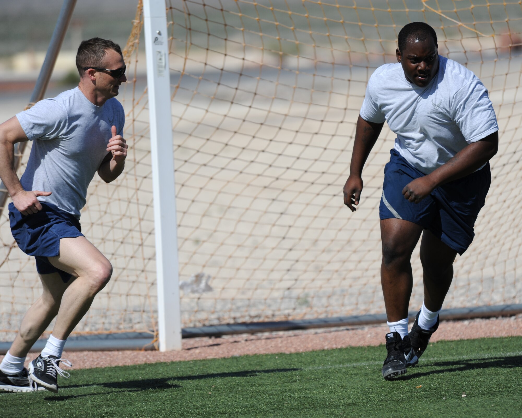 LAS VEGAS, Nev. -- Tech. Sgt. Scott encourages Airman 1st Class Christopher during a unit workout session April 9, 2013. Scott dramatically improved his fitness and has become a guru in the 432nd Aircraft Maintenance Squadron where he helps members improve their fitness. (U.S. Air Force photo by Senior Master Sgt. P.H./Released)