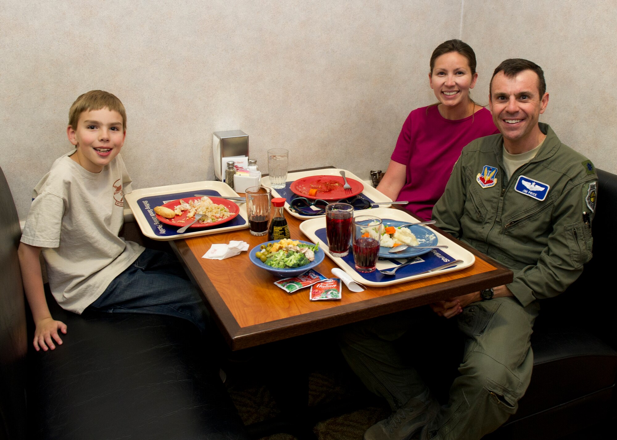 Lt. Col. James Price, 49th Operations Group commander’s special assistant, has lunch with Michelle and Erik Price at the Shifting Sands Dining Facility during Take Your Kid to Work Day at Holloman Air Force Base, N.M., April 22. Michelle and Erik got to see where he works and what he does for the Air Force. (U.S. Air Force photo by Senior Airman Kasey Close/Released)