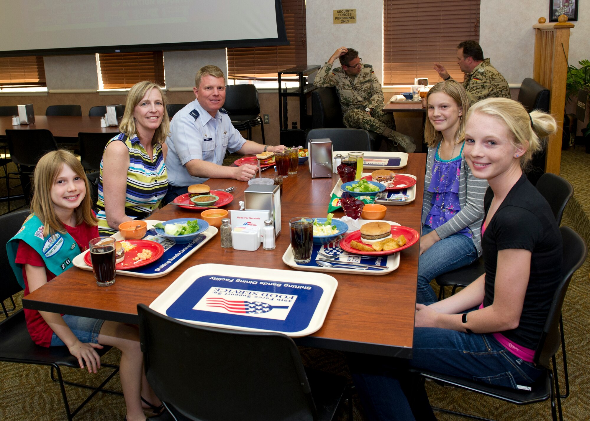 Colonel Andrew Croft, 49th Wing commander, has lunch with his family at the Shifting Sands Dining Facility during Take Your Kid to Work Day at Holloman Air Force Base, N.M., April 22. The event was held in April for the Month of the Military Child. (U.S. Air Force photo by Senior Airman Kasey Close/Released)