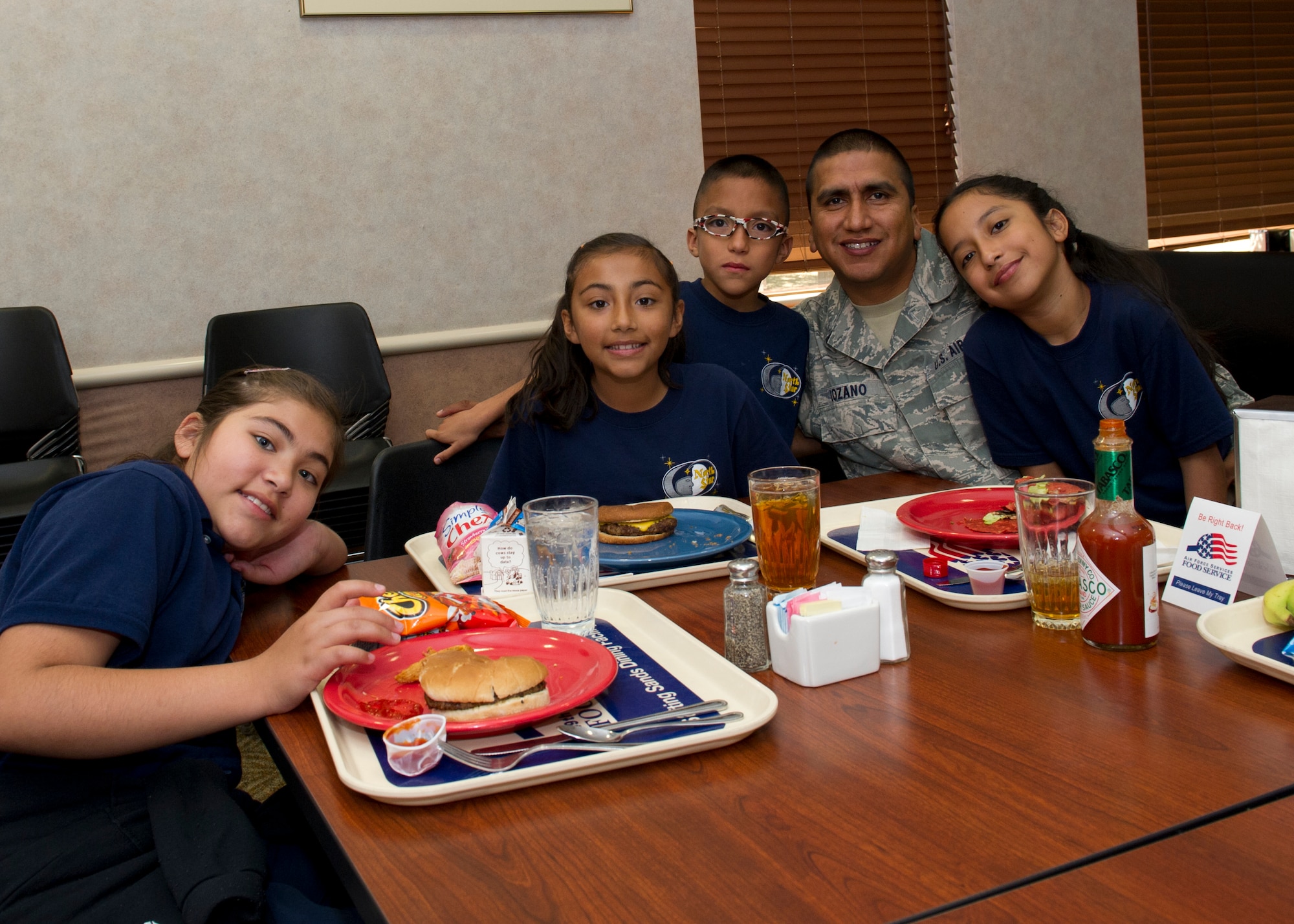 Tech. Sgt. Oscar Lozano, 49th Logistics Readiness Squadron vehicle equipment craftsman, has lunch with Lenni Rodriguez, Yamilett Rodriguez, Diego Lozano, Oscar Lozano and Nabila Lozano at the Shifting Sands Dining Facility during Take Your Kid to Work Day at Holloman Air Force Base, N.M., April 22. The children got to see where their father works and what he does for the Air Force. (U.S. Air Force photo by Senior Airman Kasey Close/Released)