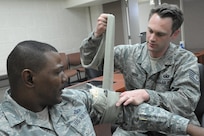 Air Force Tech. Sgt. Aaron Geer places an emergency bandage on Senior Master Sgt. Wayne Mobley during the Self-Aid Buddy Care Training Course at Joint Base San Antonio-Randolph March 13. (U.S. Air Force photo by Joel Martinez)
