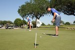 Tina Wells and Mike Meyers, Randolph High School golf team members, sharpen their putting skills April 19 at Randolph Oaks Golf Course on Joint Base San Antonio-Randolph. (U.S. Air Force photo by Melissa Peterson/ Released)