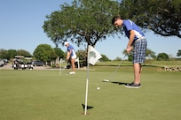 Tina Wells and Mike Meyers, Randolph High School golf team members, sharpen their putting skills April 19 at Randolph Oaks Golf Course on Joint Base San Antonio-Randolph. (U.S. Air Force photo by Melissa Peterson/ Released)