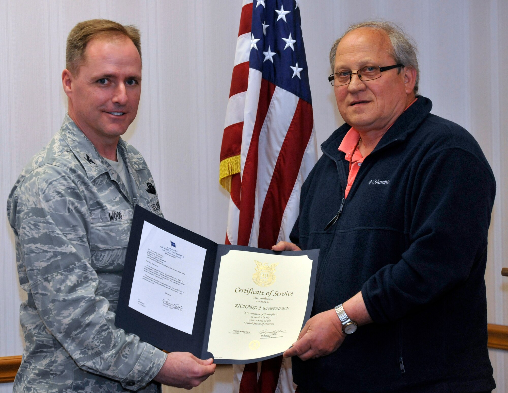 Richard J. Esbensen, 87th Civil Engineer Squadron project manager, receives a Certificate of Service for 40 years of federal service from Col. John Wood, 87th Air Base Wing commander, April 23, 2013, at Joint Base McGuire-Dix-Lakehurst, N.J. Esbensen started his career as a pipefitter apprentice for the Philadelphia Naval Shipyard in June 1969. Throughout his career, he has served as a supervisor of the Pipefitting Shop 56, a general foreman a supervisor of maintenance mechanics and the supervisor for the  Directorate of Public Works. Esbensen has worked in the 87th CES Programs Flight in 2009. (U.S. Air Force photo by Wayne Russell/Released)