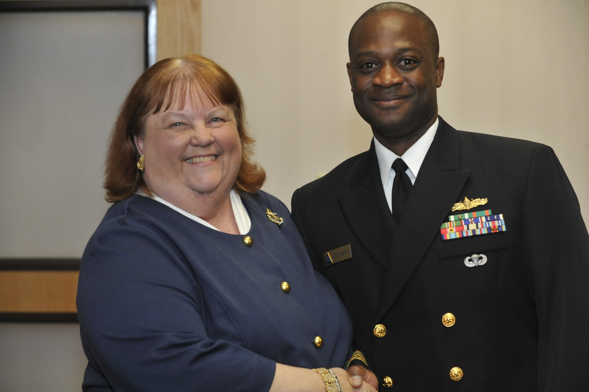 Patricia Baksa, 87th Civil Engineer Squadron emergency service and work request clerk, poses with Navy Lt. Cmdr. Donald George, 87th CES civil engineering officer, after receiving  a Certificate of Service for 40 years of federal service from Col. John Wood, 87th Air Base Wing commander, April 23, 2013, at Joint Base McGuire-Dix-Lakehurst, N.J. Patricia started her career in federal service on Nov. 27, 1967, at Naval Ammunition Depot Earle where she was part of the Federal Woman's Program, Vice-President Girl Friday Club and Miss Navy Relief. Baksa has been nominated four times  for the Base Woman of the Year Award, three times for the Base Clerical Employee of the Year Award and once for the Base People's Choice Award. (U.S. Air Force photo by Wayne Russell/Released)