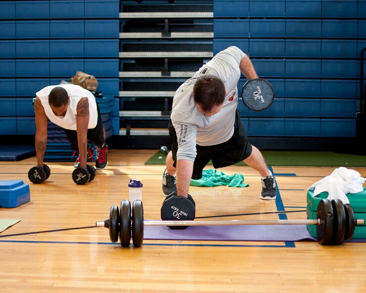 Members of the Niagara Falls Air Reserve Station engage in a fitness class offered at the Fitness Center, April 11, 2013, Niagara Falls, N.Y. The class utilizes free weights, spinning bikes, aerobic steps, kettlebells, medicine balls, suspension straps, stability balls, BOSU trainers, yoga and martial arts techniques; No two workout sessions are the same. (U.S. Air Force photo by Tech. Sgt. Joseph McKee)