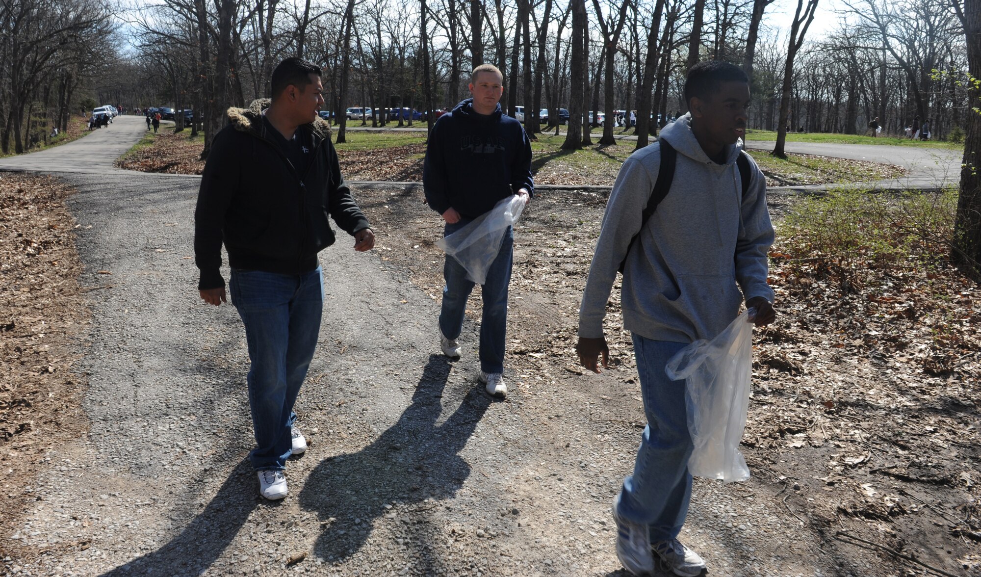 Airman 1st Class Manuel Gurrion (left), and Senior Airman James Davis and Airman 1st Class Devyn Ransom, 509th Maintenance Squadron aerospace ground equipment maintainers, prepare to pick up trash at Knob Noster State Park, Mo., April 20, 2013. Volunteers worked for more than four hours to cover as much of the park as they could during the cleanup. (U.S. Air Force photo by Airman 1st Class Bryan Crane/Released)
