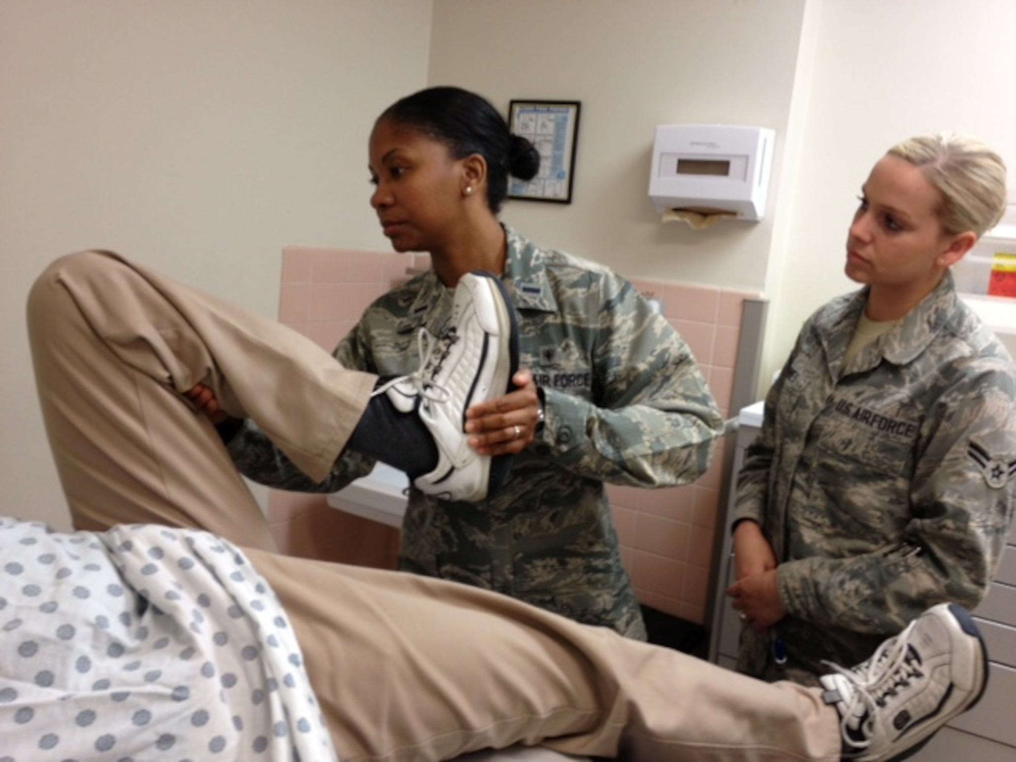 1st Lt. Kandice Perkins (left), 82nd Medical Group registered nurse, and Airman 1st Class Rochelle Jones, 82nd MDG medical technician, look over a patient at the Sheppard clinic April 25, 2013.  National Nurse/Technician Week runs from May 6-12. (U.S. Air Force courtesy photo)