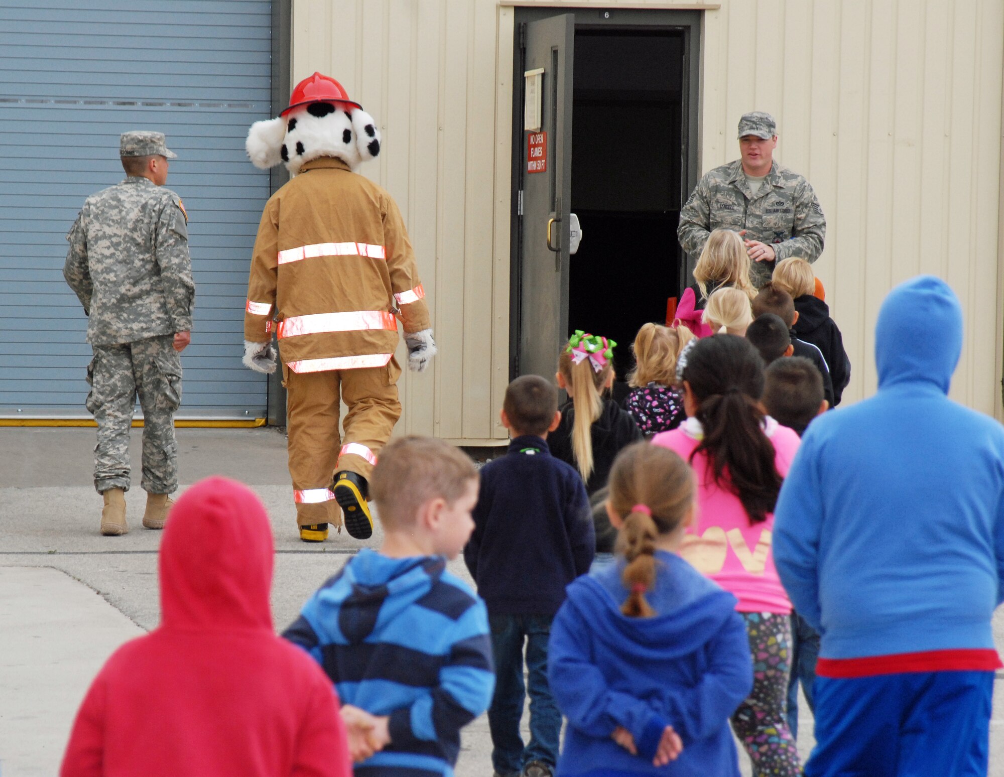GOODFELLOW AIR FORCE BASE, Texas—Youths line up to enter the High Bay at the Louis F. Garland Fire Academy, after being introduced to Sparky the Fire Dog, here, April 23. The children visited Goodfellow from Santa Rita elementary school in San Angelo. 