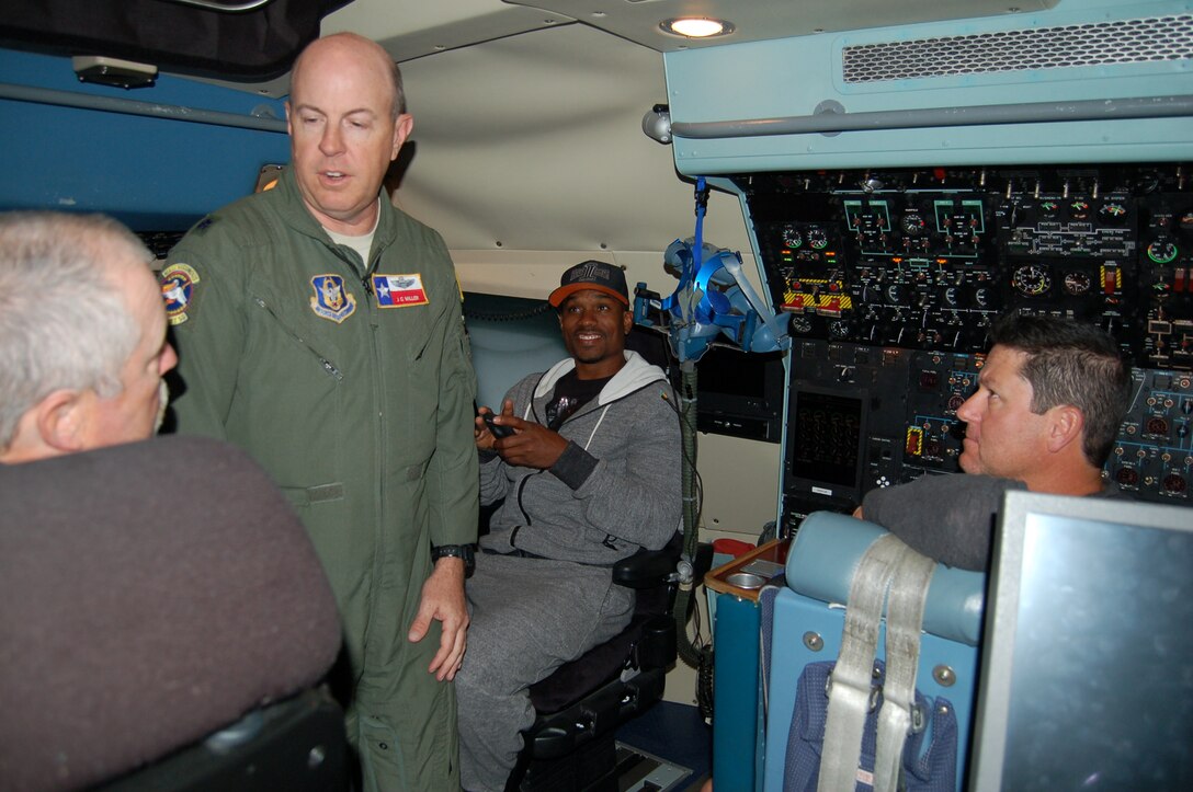 Lt. Col. J.C. Miller, center left, 68th Airlift Squadron operations officer and C-5A Galaxy pilot, answers questions about the C-5 simulator from former Major League Baseball Randall Glenn Johnson, former third baseman and now Padres' minor-league field coordinator; Jacque Jones, former outfielder and now the Fort Wayne TriCaps hitting coach; and Mike Cather, former pitcher and now a Padres' roving minor league pitching coordinator on Joint Base San Antonio-Lackland on April 24.  The San Antonio Missions are the minor league Class AA affiliate of the Padres. 