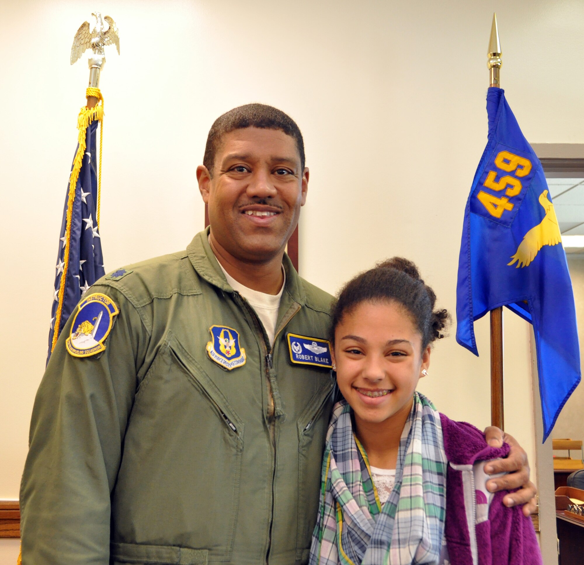 U.S. Air Force Lt. Col. Robert Blake, commander of the 756th Aerial Refueling Squadron, poses for a picture with his daughter, Elizabeth, for Take Your Child to Work Day, at Joint Base Andrews, Md., April 25, 2012. Take Your Child to Work Day is a day where parents can bring their children into the workplace to highlight the different opportunities available to them and to promote a positive attitude for their future. (U.S. Air Force photo/ Staff Sgt. Katie Spencer)