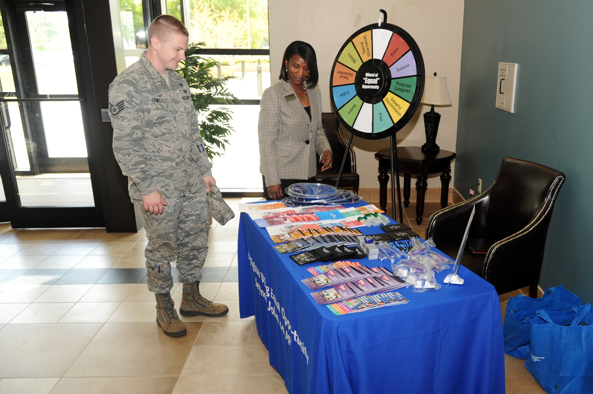 U.S. Air Force Staff Sgt. Jacob Hewitt, 4th Fighter Wing paralegal, looks at a display setup at an Equal Opportunity information fair on Seymour Johnson Air Force Base, N.C., April 23, 2013.  Interested participants were invited to spin the “Wheel of Equal Opportunity” to receive additional prizes.  (U.S. Air Force photo by Airman 1st Class Brittain Crolley/Released)