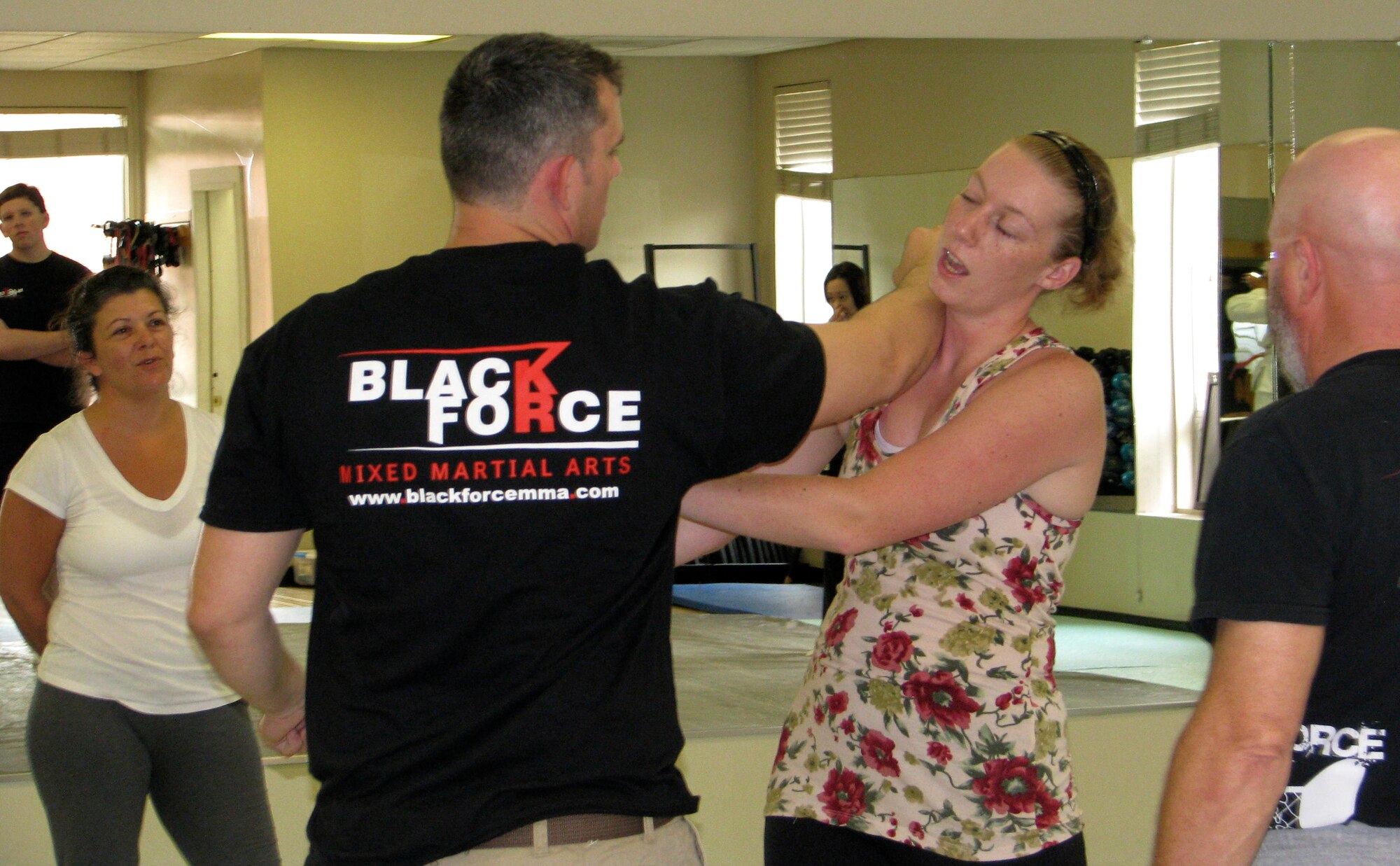 Navy Chief  Petty Officer Chad Booth, Black Force MMA instructor, demonstrates a defensive-attack during the Women’s Self-Defense Seminar April 20, 2013, at the Morale, Welfare and Recreation Athletics Facility at Joint Base Charleston – Weapons Station, S.C. This free, two-hour clinic, as part of the activities of Sexual Assault Awareness Month, was presented by Black Force MMA Academy and was designed to educate females about their options for self-defense. (Courtesy photo)