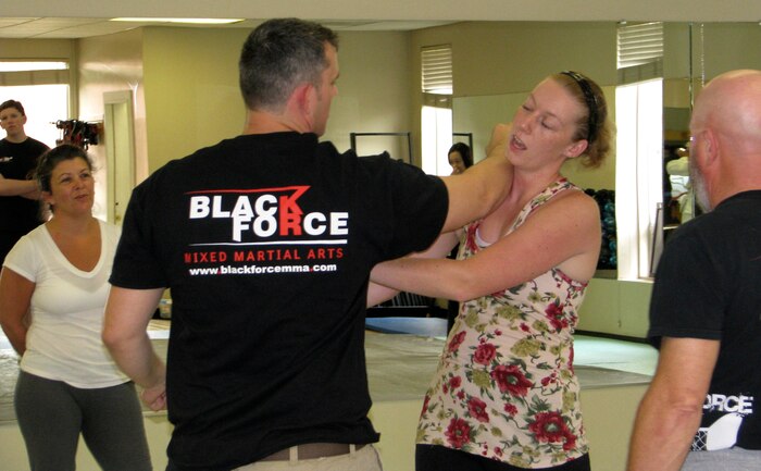 Navy Chief  Petty Officer Chad Booth, Black Force MMA instructor, demonstrates a defensive-attack during the Women’s Self-Defense Seminar April 20, 2013, at the Morale, Welfare and Recreation Athletics Facility at Joint Base Charleston – Weapons Station, S.C. This free, two-hour clinic, as part of the activities of Sexual Assault Awareness Month, was presented by Black Force MMA Academy and was designed to educate females about their options for self-defense. (Courtesy photo)