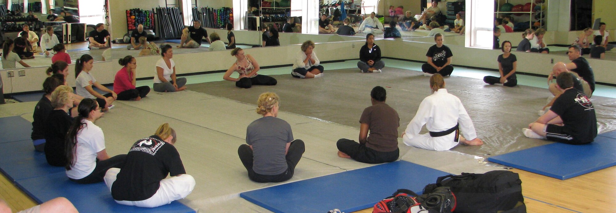 Participants perform stretching exercises during the Women’s Self-Defense Seminar April 20, 2013 at the Morale, Welfare and Recreation Athletics Facility at Joint Base Charleston – Weapons Station, S.C. This free, two-hour clinic, was part of the activities of Sexual Assault Awareness Month and was presented by Black Force MMA Academy and was designed to educate females about their options for self-defense. (Courtesy photo)