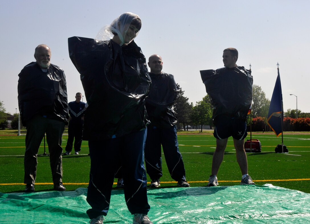 Senior Master Sgt. Robin McConnell, 11th Operations Group executive officer, mentally prepares for a pie in the face during an outdoor 11 OG commander’s call at Joint Base Anacostia-Bolling April 23, 2013. As a part of the Air Force Assistance Fund donation drive, the 11 OG raised more than 500 dollars from their pie-in-the-face contest. (U.S. Air Force photo/Senior Airman Lindsey A. Porter)