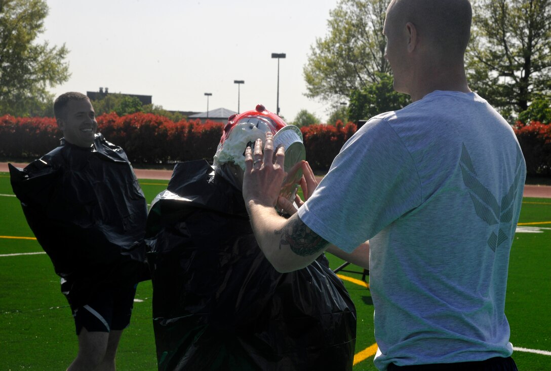 Senior Master Sgt. Robin McConnell, 11th Operations Group executive officer, receives a pie in the face during an outdoor 11 OG commander's call at Joint Base Anacostia-Bolling on April 23, 2013. As a part of the Air Force Assistance Fund donation drive, the 11 OG raised more than $500 from their pie-in-the-face contest. (U.S. Air Force photo/Senior Airman Lindsey A. Porter)