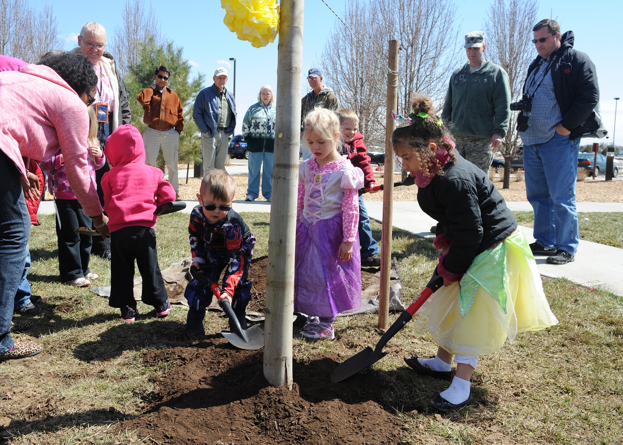 Children from the A-Basin Child Development Center shovel dirt April 24, 2013, at Buckley Air Force Base, Colo. Given a chance to play in the dirt, the children made sure all of the dirt was replaced around the tree planted in celebration of Arbor Day. (U.S. Air Force photo by Senior Airman Marcy Glass/Released)