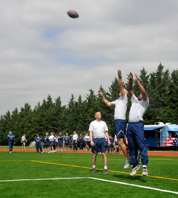 Members of the U.S. Air Force Honor Guard and Air Force Arlington Chaplaincy participate in a pickup football game during an outdoor 11th Operations Group commander's call at Joint Base Anacostia-Bolling April 23, 2013. The commander's call presented the group with their quarter and annual awards in between scheduled recreational events that raised money for the Air Force Assistance Fund as well as maintained camaraderie and morale of all within the unit. (U.S. Air Force photo/Senior Airman Lindsey A. Porter)