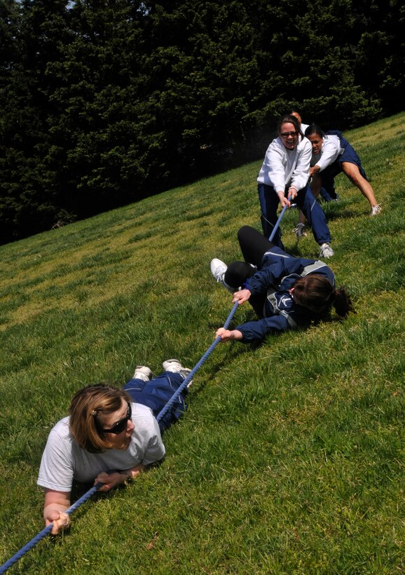 Refusing to give up, ladies from the 11th Operations Group participate in an all-female tug-of-war competition during an 11th OG commander's call at Joint Base-Anacostia Bolling April 23, 2013. The commander's call was held in order to present the 11 OG's three units with their quarter and annual awards, raise money for the Air Force Assistance Fund, as well as build camaraderie and maintain the morale of all within each unit. (U.S. Air Force photo/Senior Airman Lindsey A. Porter)