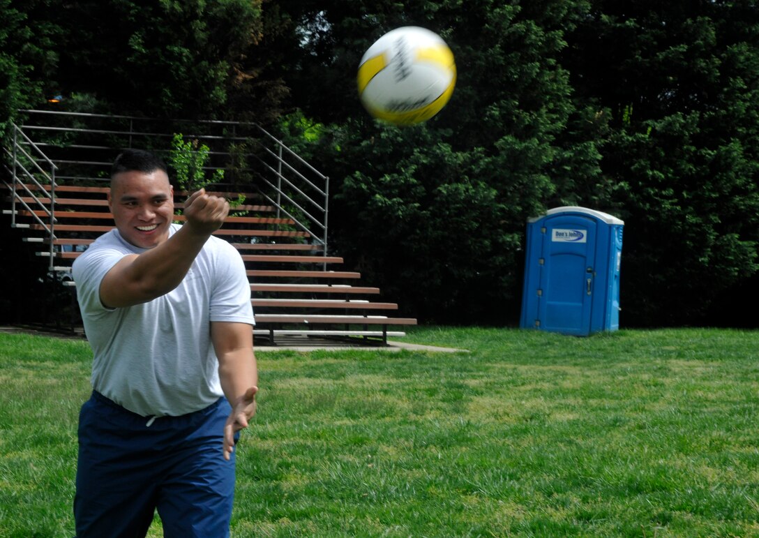 Airman 1st Class Lutelu Maui, U.S. Air Force Honor Guard operations scheduler, serves a volleyball during an outdoor 11th Operations Group commander's call at Joint Base Anacostia-Bolling April 23, 2013. The commander's call was held in order to present the group with their quarter and annual awards as well as afford the group a venue to raise money for the Air Force Assistance Fund and maintain the camaraderie and morale of the unit. (U.S. Air Force photo/Senior Airman Lindsey A. Porter)