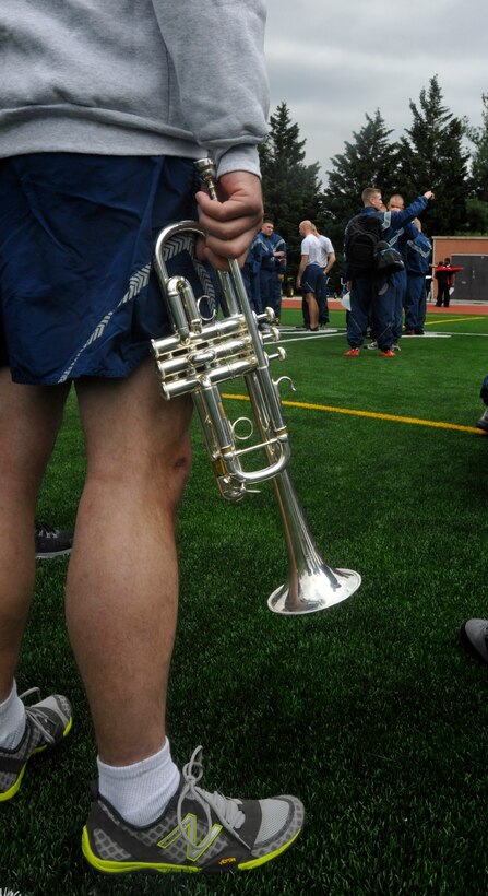 A U.S. Air Force Band bugler waits for his queues during an 11th Operations Group  outdoor commander's call held at Joint Base Anacostia-Bolling on April 23, 2013.The commander's call was held in order to present the group with their quarter and annual awards in between scheduled recreational activities that were signaled through the use of a bugle call. (U.S. Air Force photo/Senior Airman Lindsey A. Porter)