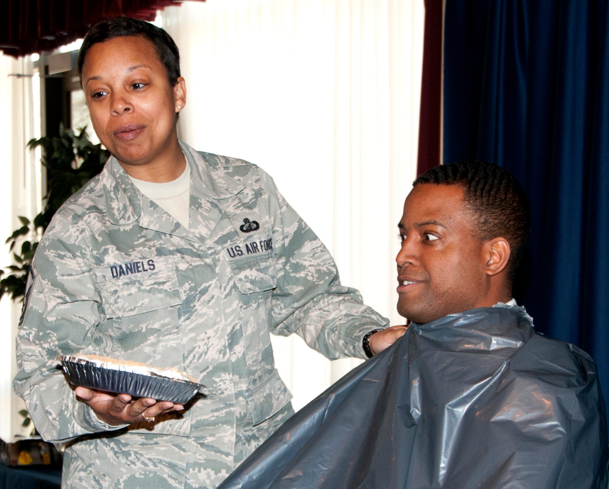 Chris Daniels anticipates getting a face full of pudding and cream pie from his wife, Master Sgt. Erica Daniels, during the Rising 4 “Pie in the Eye” event, April 24, at Vance Air Force Base, Okla. (U.S. Air Force photo/ Staff Sgt. James Bolinger)