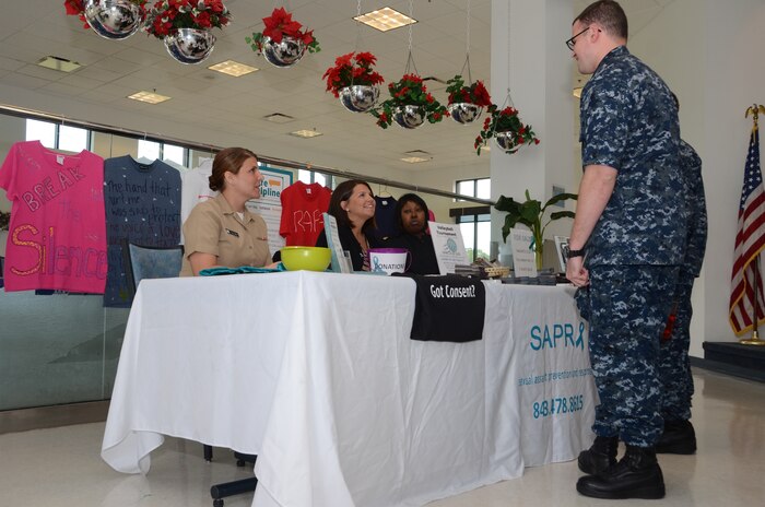 Navy Sexual Assault Prevention and Response victim advocate Lt.j.g. Amy Ellison, Naval Nuclear Power Training Command, Tiffany Mizzell, Joint Base Charleston - Weapons Station Sexual Assault Response coordinator, and Chief Petty Officer Andrella Pusha, NNPTC victim advocate, discuss SAPR awareness with NNPTC students at the JB Charleston - Weapons Station Galley, April 22, 2013. The SAPR informational awareness tables are just one of the many events designed to highlight and increase SAPR consciousness onboard the Weapons Station and throughout JB Charleston. (U.S. Navy photo/ Petty Officer 1st Class Chad Hallford)


