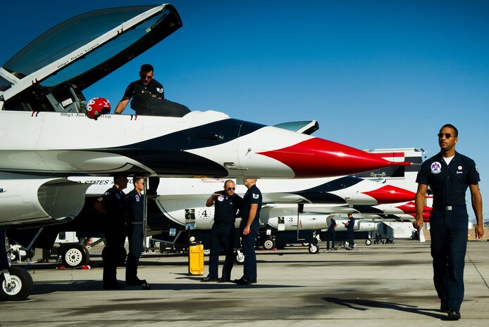 Staff Sgt. Benjamin Ayivorh, Thunderbird 7 dedicated crew chief, walks to his F-16 jet to prepare it for engine runs April 23, 2013, at Nellis Air Force Base, Nev.  Ayivorh said he joined the Thunderbirds team for a chance to represent the U.S. Air Force. (U.S. Air Force photo by Tech. Sgt. Manuel J. Martinez)  