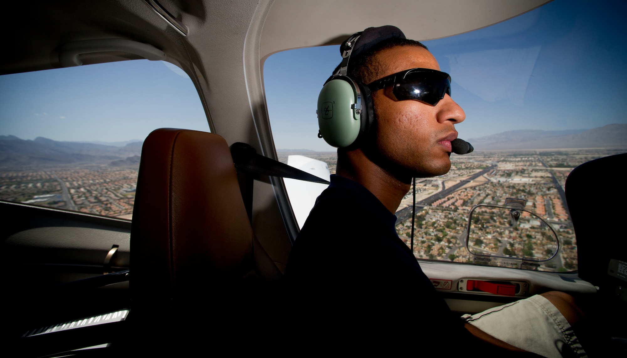 Staff Sgt. Benjamin Ayivorh, Thunderbird 7 dedicated crew chief, flies over Las Vegas,  April 22, 2013.  Ayivorh developed a love for aviation at a young age. (U.S. Air Force photo by Tech. Sgt. Manuel J. Martinez)