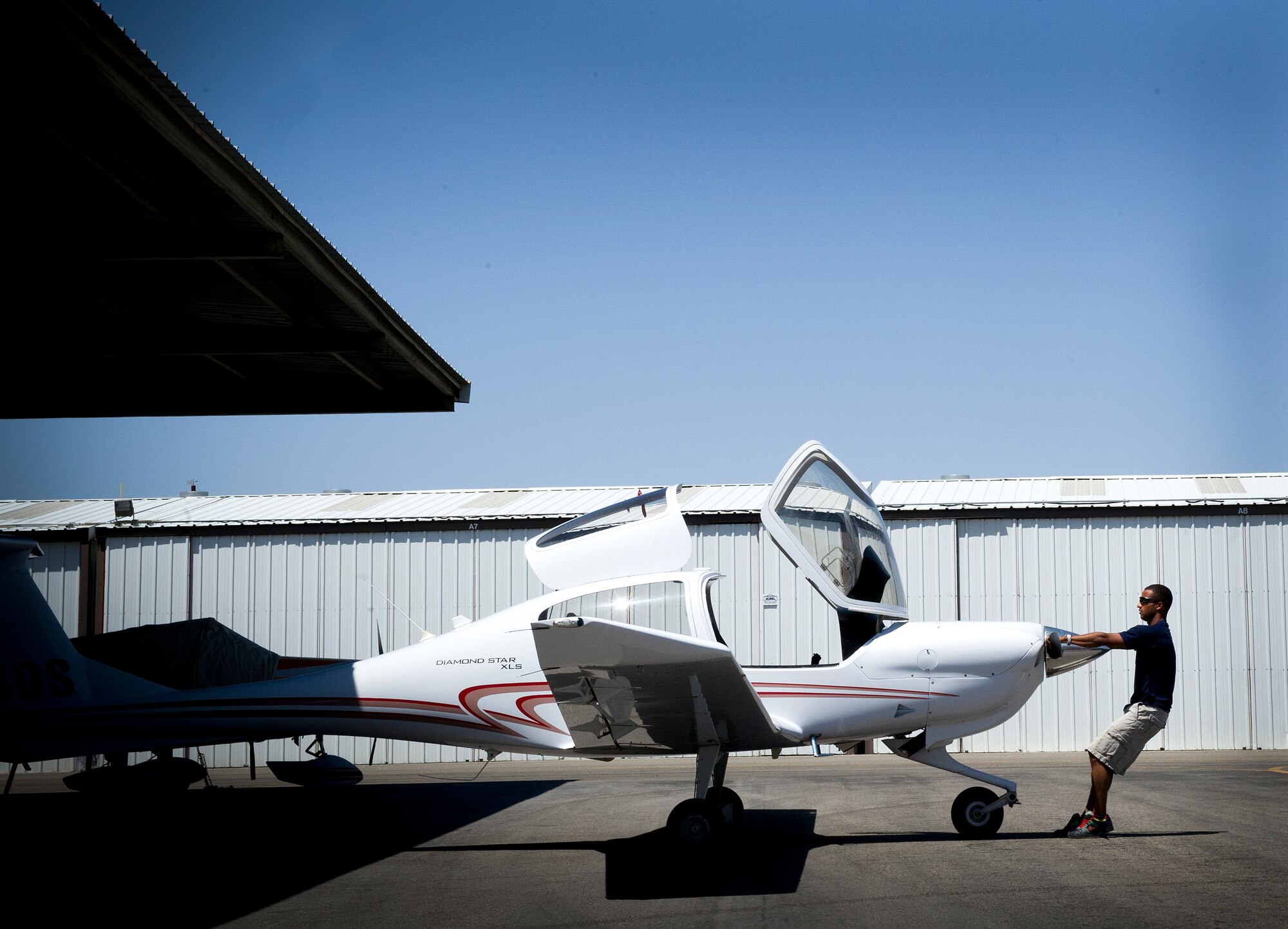 Staff Sgt. Benjamin Ayivorh, Thunderbird 7 dedicated crew chief, prepares a DA-40 aircraft for an afternoon flight at North Las Vegas Airport,  April 22, 2013.  Ayivorh earned his private pilot’s license in 2010 and has more than 80 hours of flight time. (U.S. Air Force photo/Tech. Sgt. Manuel J. Martinez)