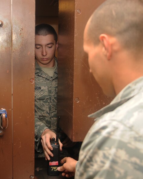 Airman 1st Class Tracker Hardin, 2nd Security Forces Squadron patrolman, receives his radio from the armory on Barksdale Air Force Base, La., April 24, 2013. The 2 SFS armory is in charge of issuing all equipment including weapons, ammunition, radios and asp batons to Airmen. (U.S. Air Force photo/Senior Airman Sean Martin)