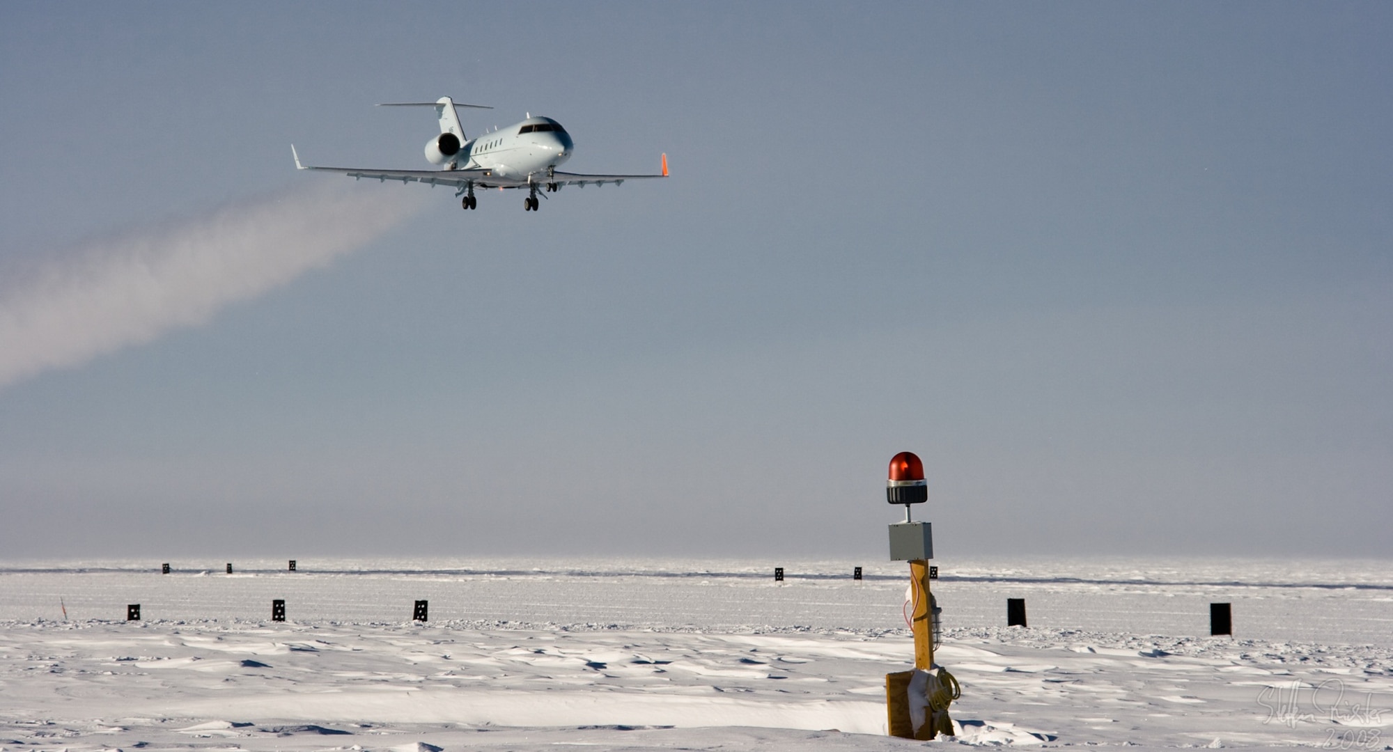 A Bombardier Challenger flown by a 1st Aviation Standards Flight crew, flies over McMurdo Station, Antarctica. The 1st ASF is a small team of reservists performing critical inspections to ensure aircraft take off and land safely in locations all around the world.  They are the only teams in the world qualified to inspect McMurdo Station. (Courtesy Photo)