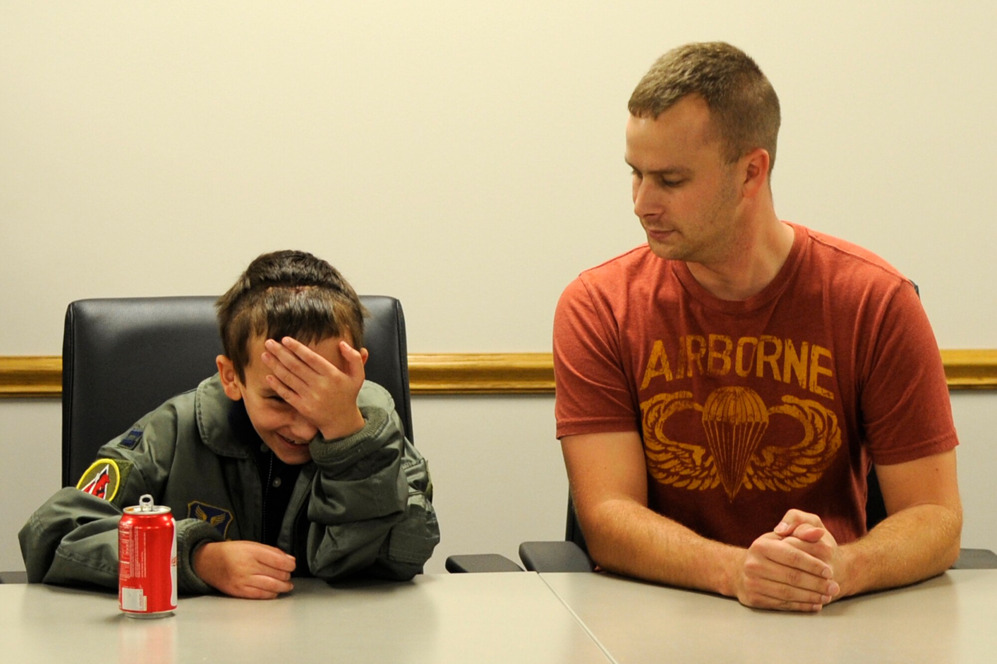 Kevin Tomlin and his son Hunter wait for a presentation ceremony to begin at Barksdale Air Force Base, La., April 24, 2013. Hunter, who has Neurofibromatosis Type 1, also known as von Recklinghausen disease, is recovering from surgery performed to remove a tumor from his face that hindered his ability to breathe through his nose. Members of the 307th and 2nd Aircraft Maintenance Squadrons made Hunter’s dream come true by presenting him with an Air Force uniform, a tour of a B-52 Stratofortress and mementos of his visit to Barksdale. (U.S. Air Force photo by Master Sgt. Jeff Walston)