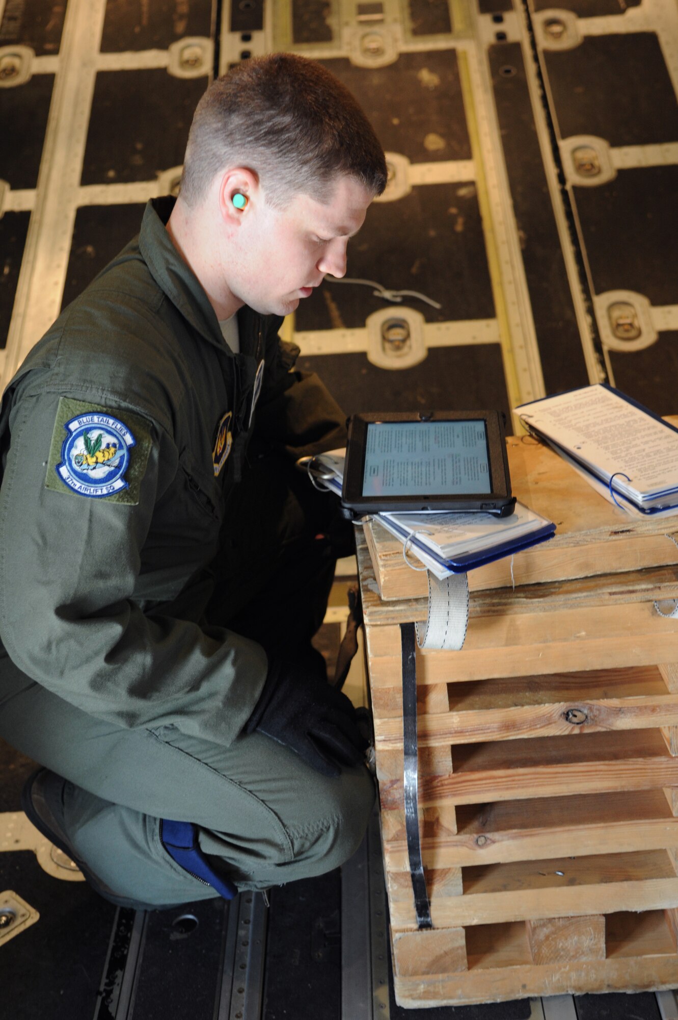 Airman 1st Class Tyler Fulling, 37th Airlift Squadron loadmaster, reads through the checklist of installing a static-line in a C-130J Super Hercules during Carpathian Spring, April 17, 2013, Bucharest, Romania. The training mission was designed for aircrew to receive upgrade training as well as building partnership capacity with Romanians. (U.S. Air Force photo/Airman 1st Class Hailey Haux)