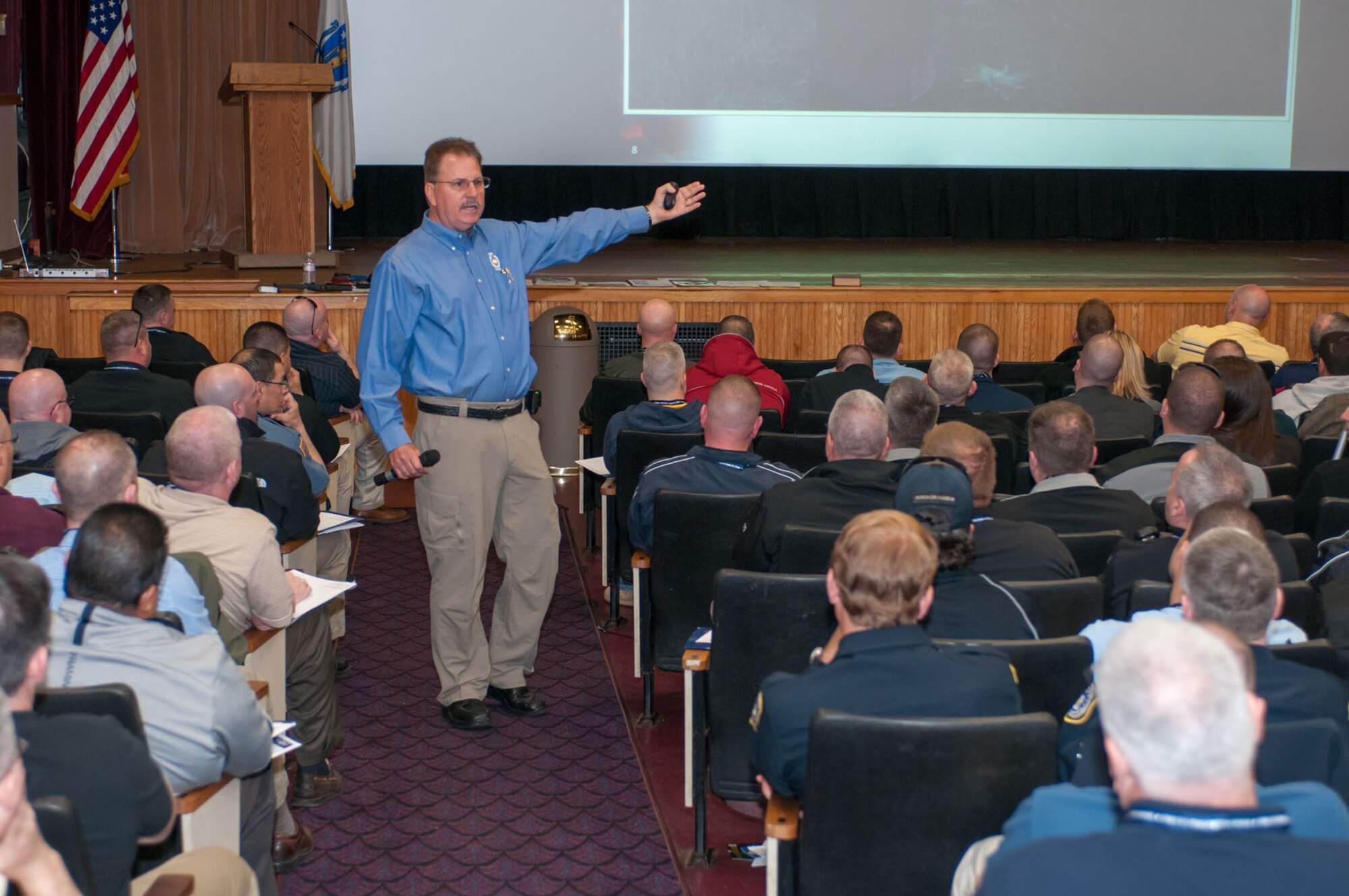 HANSCOM AIR FORCE BASE, Mass. – Retired Capt. Tom Gleason, Florida Department of Financial Services, teaches the Armed Subject Indicators and Approach Techniques portion of the VALOR training in the base theater April 17. The training was available to local, national and military law enforcement personnel. (U.S. Air Force photo by Rick Berry)